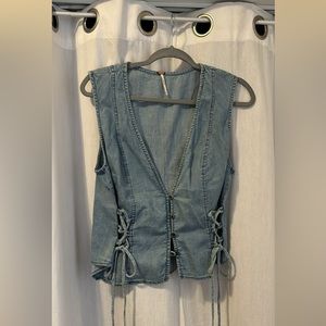 Jean vest with lace up sides and button up front.